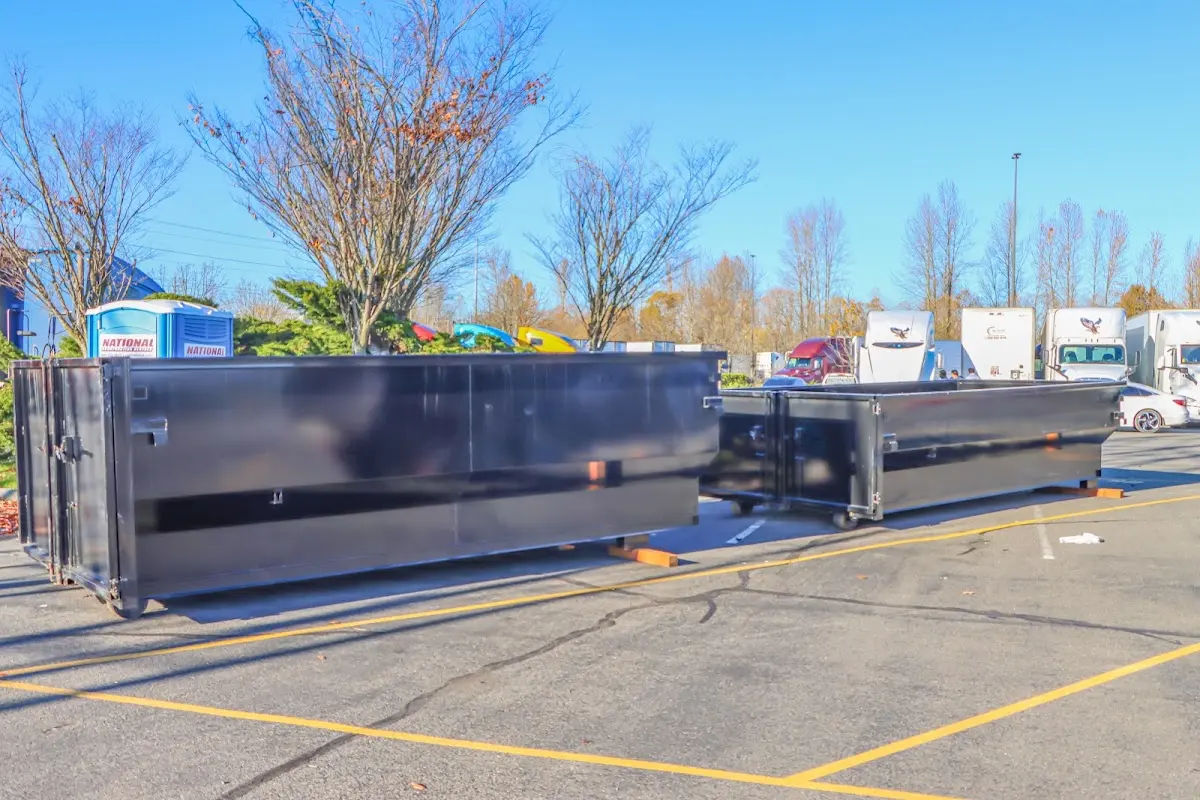 Professional dumpster rental service with roll-off container on residential driveway in Saddle Brook